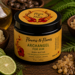 Flowers N Flames Archangel for Him Body Butter in a black jar with a kraft label, handcrafted with botanical butters, bergamot, and frankincense on a rustic wooden surface.