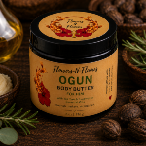 Flowers N Flames Ogun Body Butter in a black jar with a kraft label, handcrafted with botanical butters, tea tree, eucalyptus, and rosemary on a rustic wooden surface.
