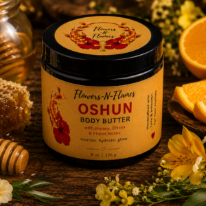 Flowers N Flames Oshun Body Butter in a black jar with a kraft label, handcrafted with botanical butters and a warm honey, citrus, and floral fragrance on a rustic wooden surface.