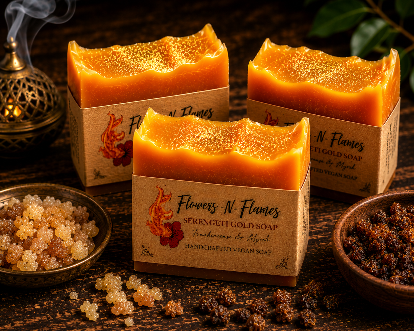 Flowers N Flames Serengeti Gold Soap resting on a rustic wooden surface beside frankincense resin, myrrh, warm amber accents, and botanical elements, wrapped in the signature kraft paper label.